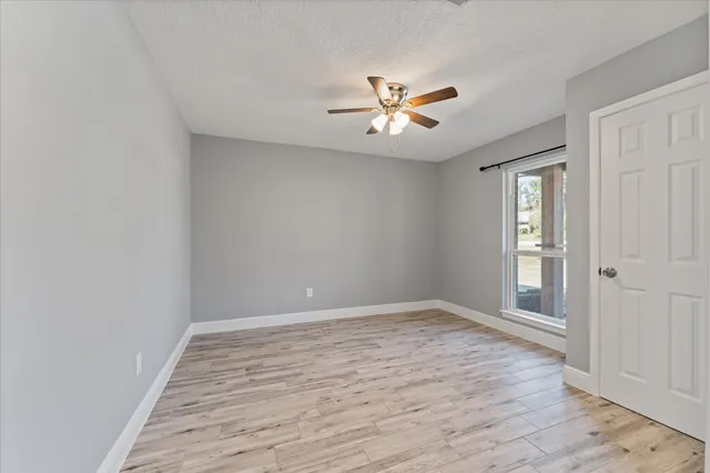 wooden floor in an empty room with a window