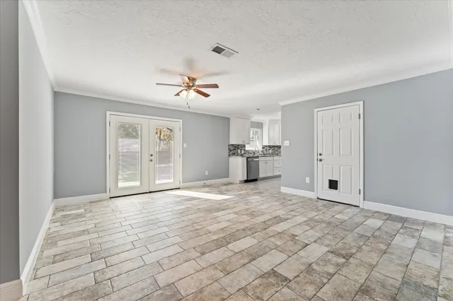 a kitchen with a white cabinets and a window