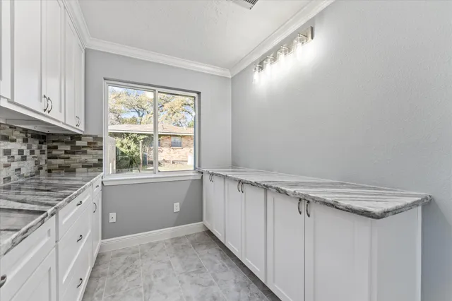 a kitchen with stainless steel appliances and chandelier