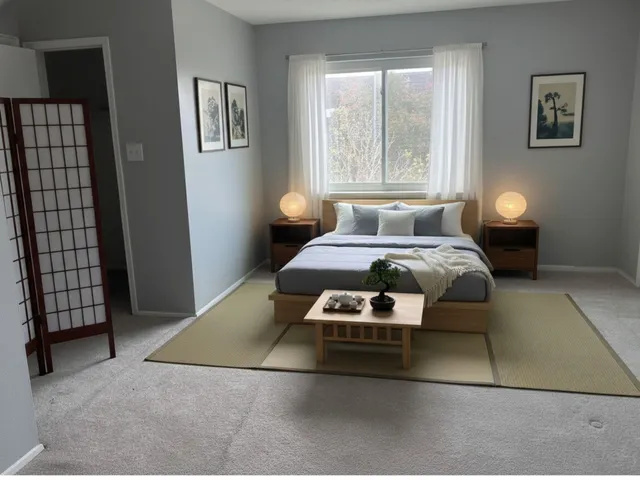 a bedroom with a bed and a window