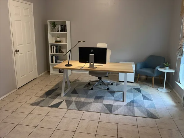a work room with furniture a rug and a table