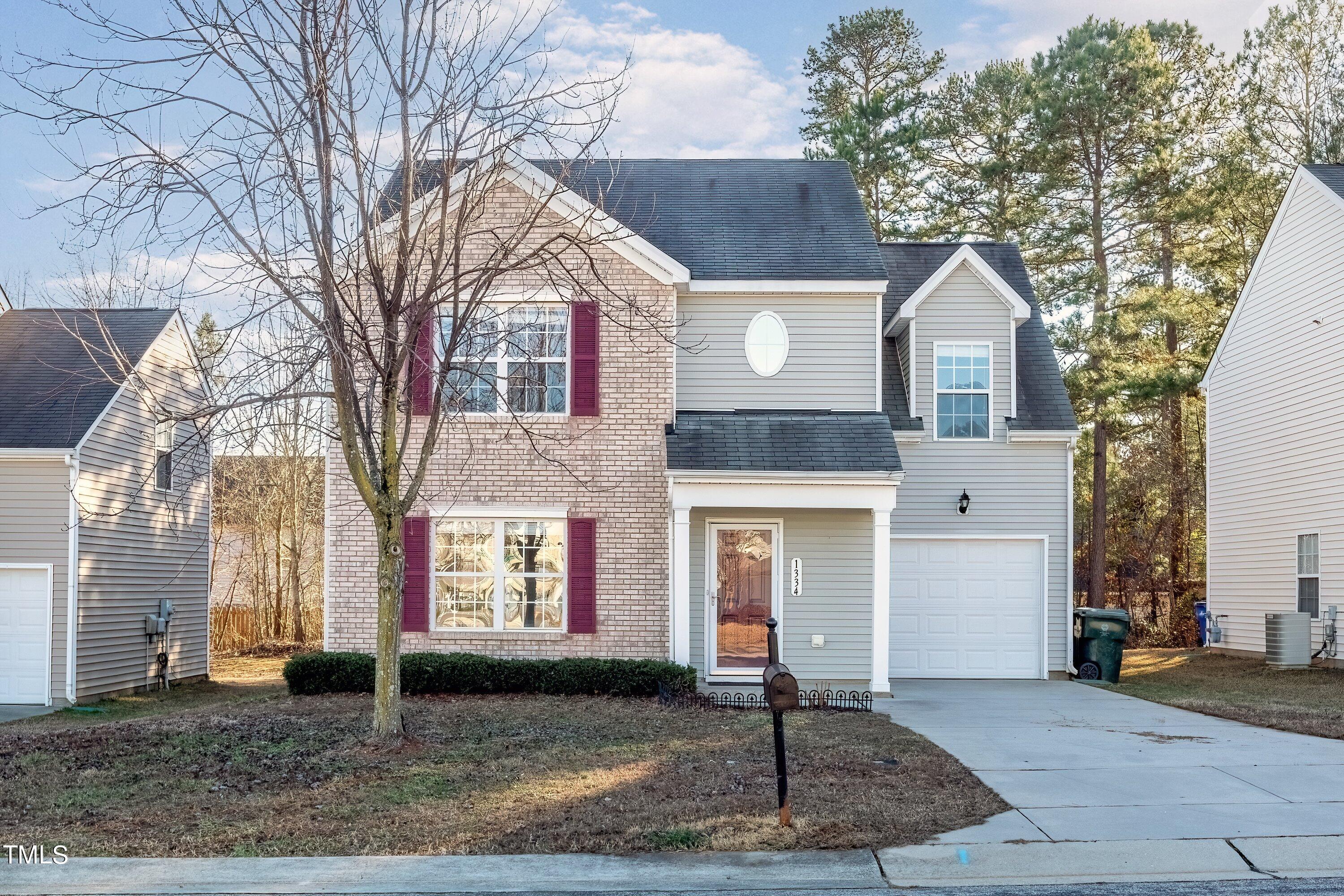 1334 Ricochet Drive Raleigh, NC 27610 - Photo 3 of 40 a front view of a house with garden