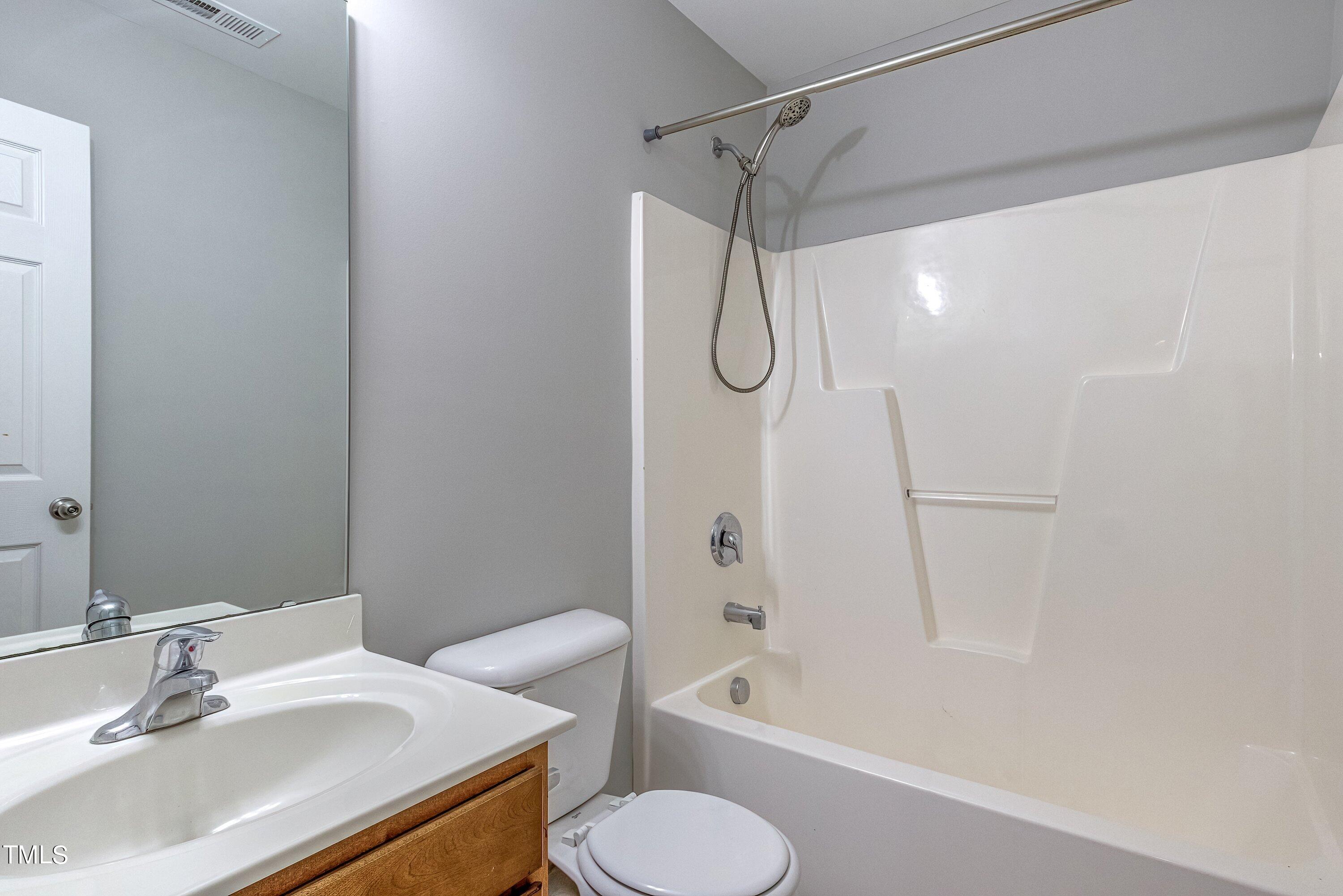 1334 Ricochet Drive Raleigh, NC 27610 - Photo 35 of 40 a bathroom with a sink toilet and shower