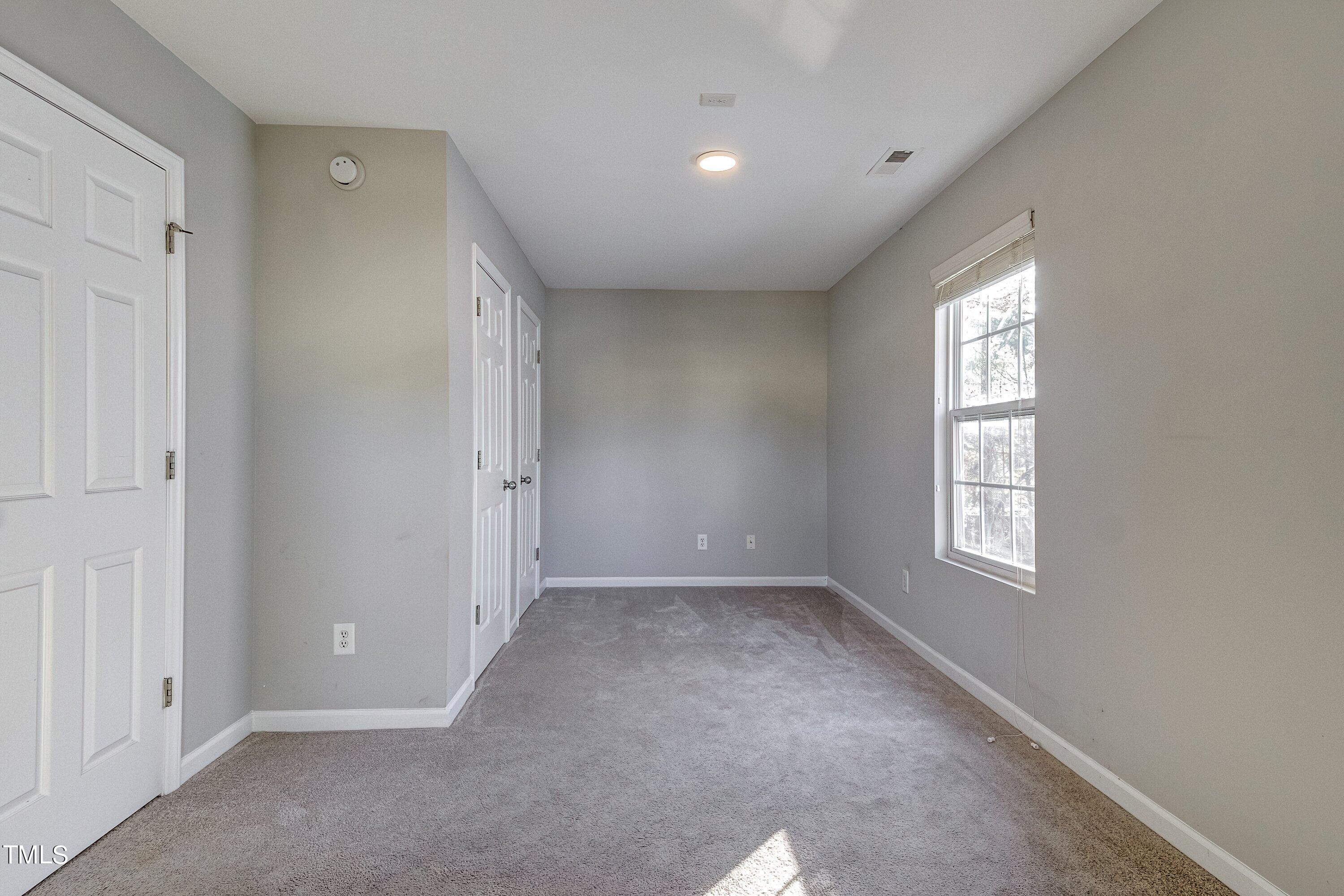 1334 Ricochet Drive Raleigh, NC 27610 - Photo 36 of 40 an empty room with windows and closet
