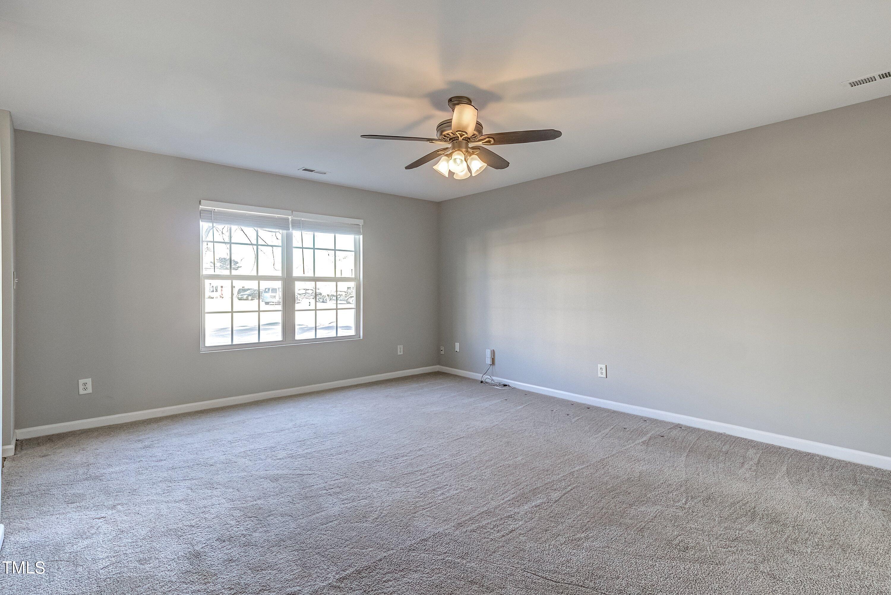 1334 Ricochet Drive Raleigh, NC 27610 - Photo 8 of 40 wooden floor in an empty room with a window