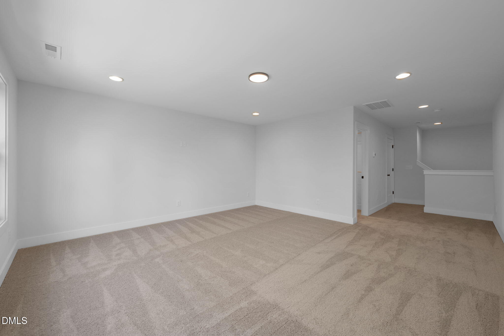 966 Double Helix Road Apex, NC 27523 - Photo 27 of 36 an empty room with white wall and natural light
