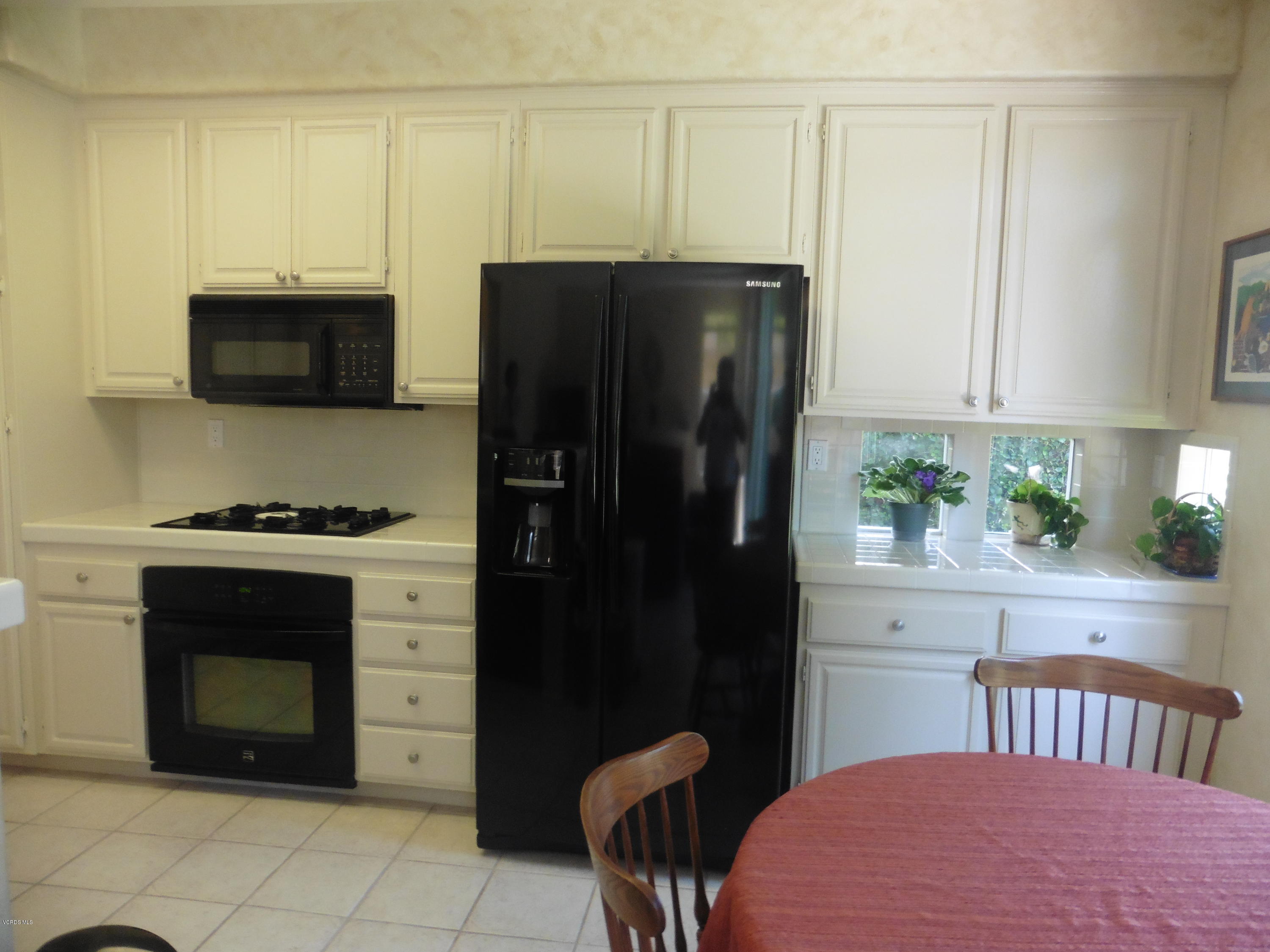 11285 Shadyridge Road Moorpark, CA 93021 - Photo 8 of 31 a kitchen with stainless steel appliances a refrigerator stove and microwave