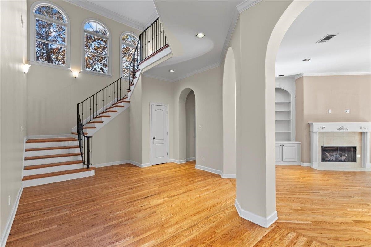 170 Jamerson Farm Road Collierville, TN 38017 - Photo 16 of 40 Foyer featuring a fireplace, light hardwood / wood-style flooring, and crown molding