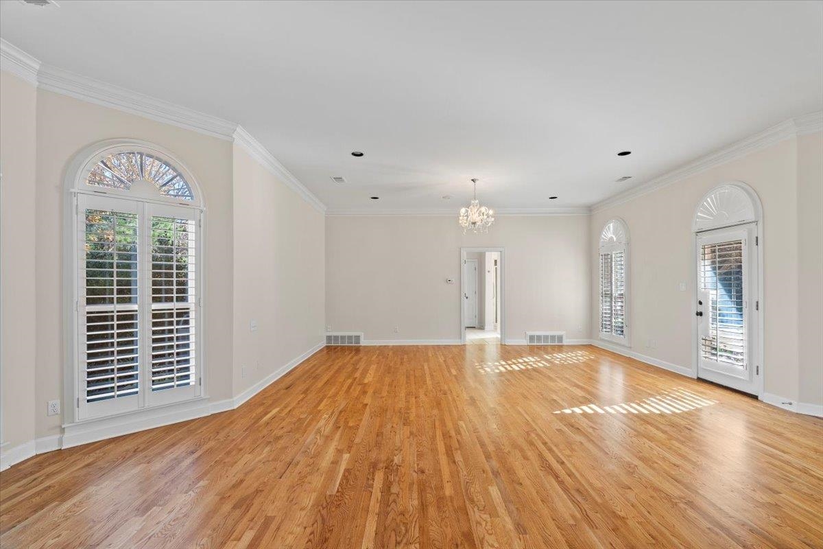 170 Jamerson Farm Road Collierville, TN 38017 - Photo 18 of 40 Empty room with a notable chandelier, ornamental molding, and light hardwood / wood-style flooring