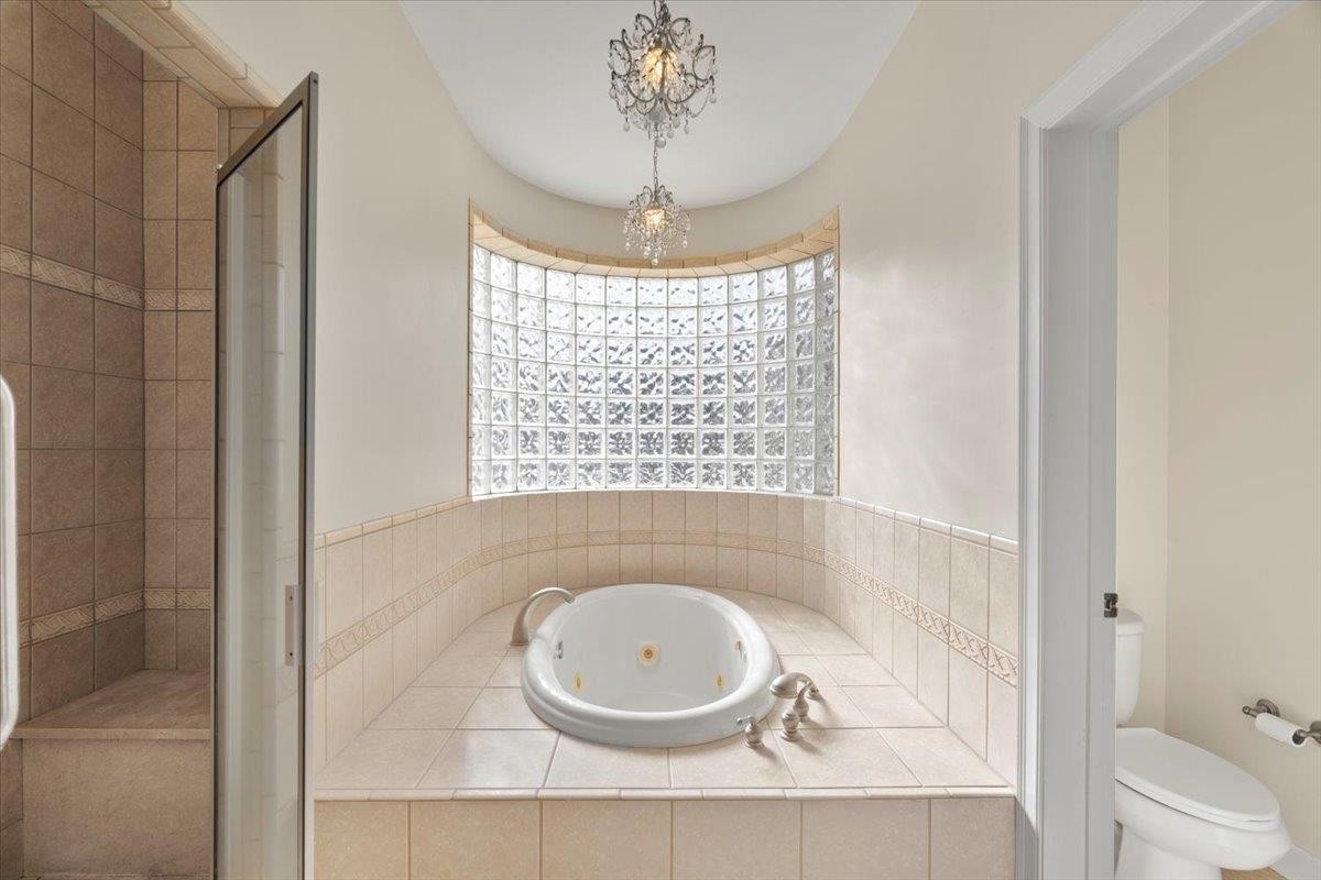 170 Jamerson Farm Road Collierville, TN 38017 - Photo 21 of 40 Bathroom featuring plus walk in shower, a chandelier, and toilet