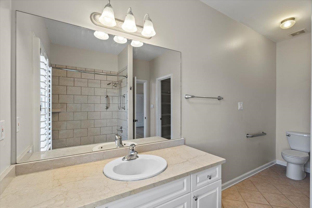 170 Jamerson Farm Road Collierville, TN 38017 - Photo 27 of 40 Bathroom with a tile shower, tile patterned flooring, vanity, and toilet
