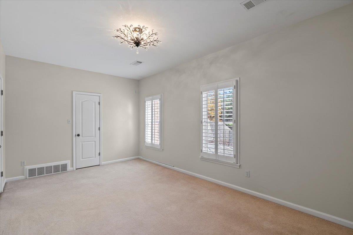 170 Jamerson Farm Road Collierville, TN 38017 - Photo 31 of 40 Unfurnished room with light carpet and a chandelier