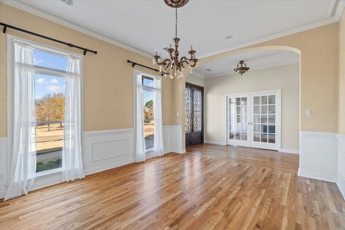 170 Jamerson Farm Road Collierville, TN 38017 - Photo 5 of 40 Unfurnished dining area featuring light hardwood / wood-style flooring, a chandelier, french doors, and ornamental molding