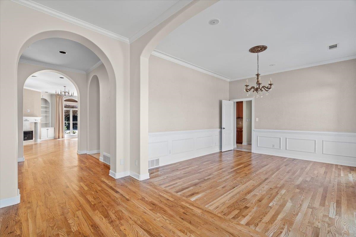 170 Jamerson Farm Road Collierville, TN 38017 - Photo 8 of 40 Unfurnished room with light hardwood / wood-style floors, crown molding, and a notable chandelier