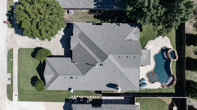 an aerial view of a house with a swimming pool