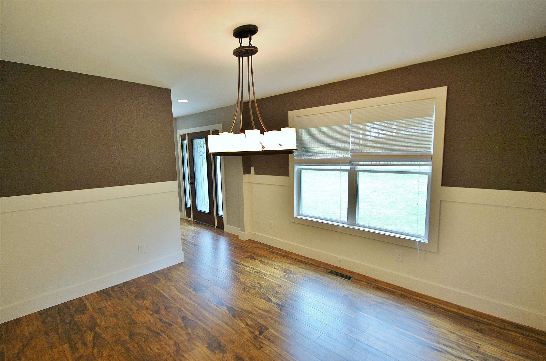 54 Snow Tree Bend Manchester, TN 37355 - Photo 2 of 16 a view of an empty room with window and wooden floor