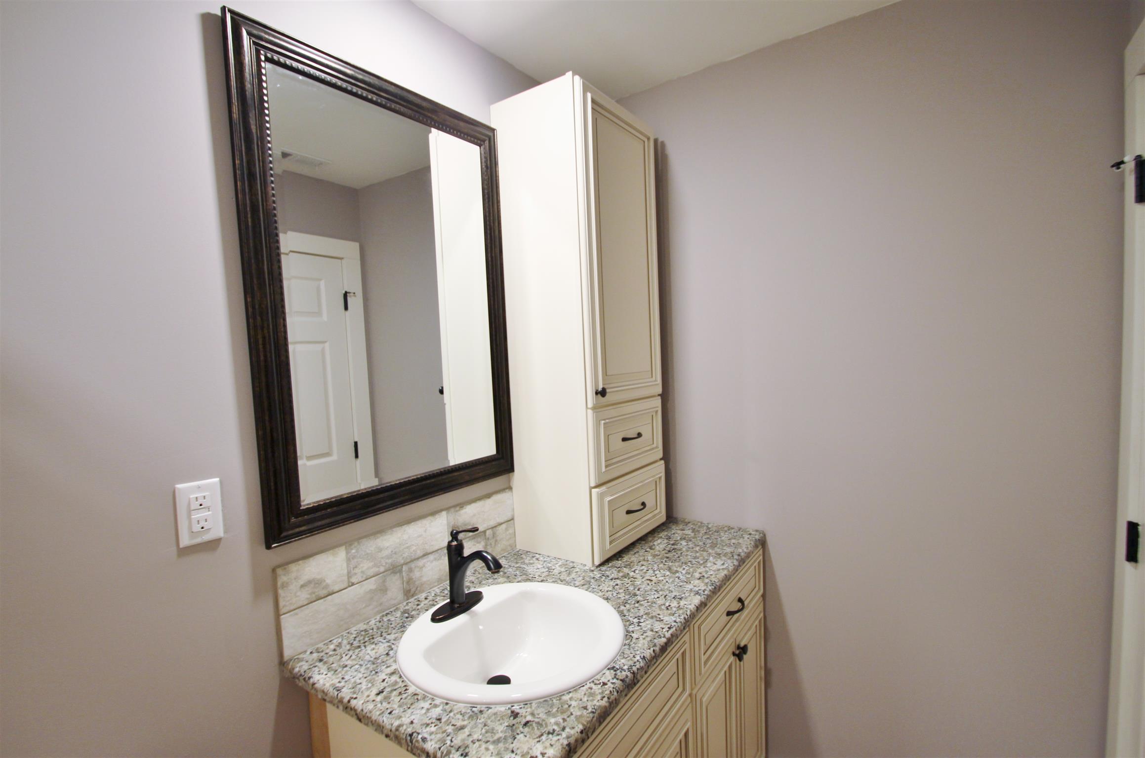 54 Snow Tree Bend Manchester, TN 37355 - Photo 13 of 16 a bathroom with a granite countertop sink and a mirror
