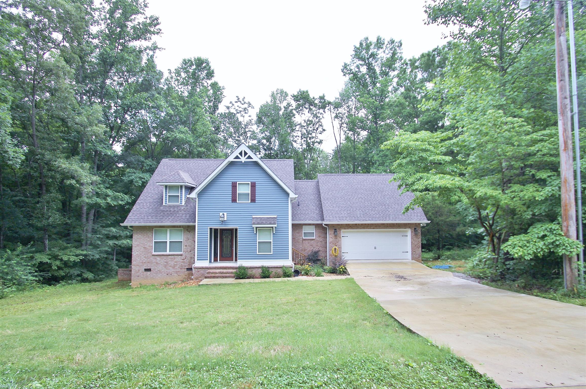 54 Snow Tree Bend Manchester, TN 37355 - Photo 16 of 16 a front view of a house with a garden and trees