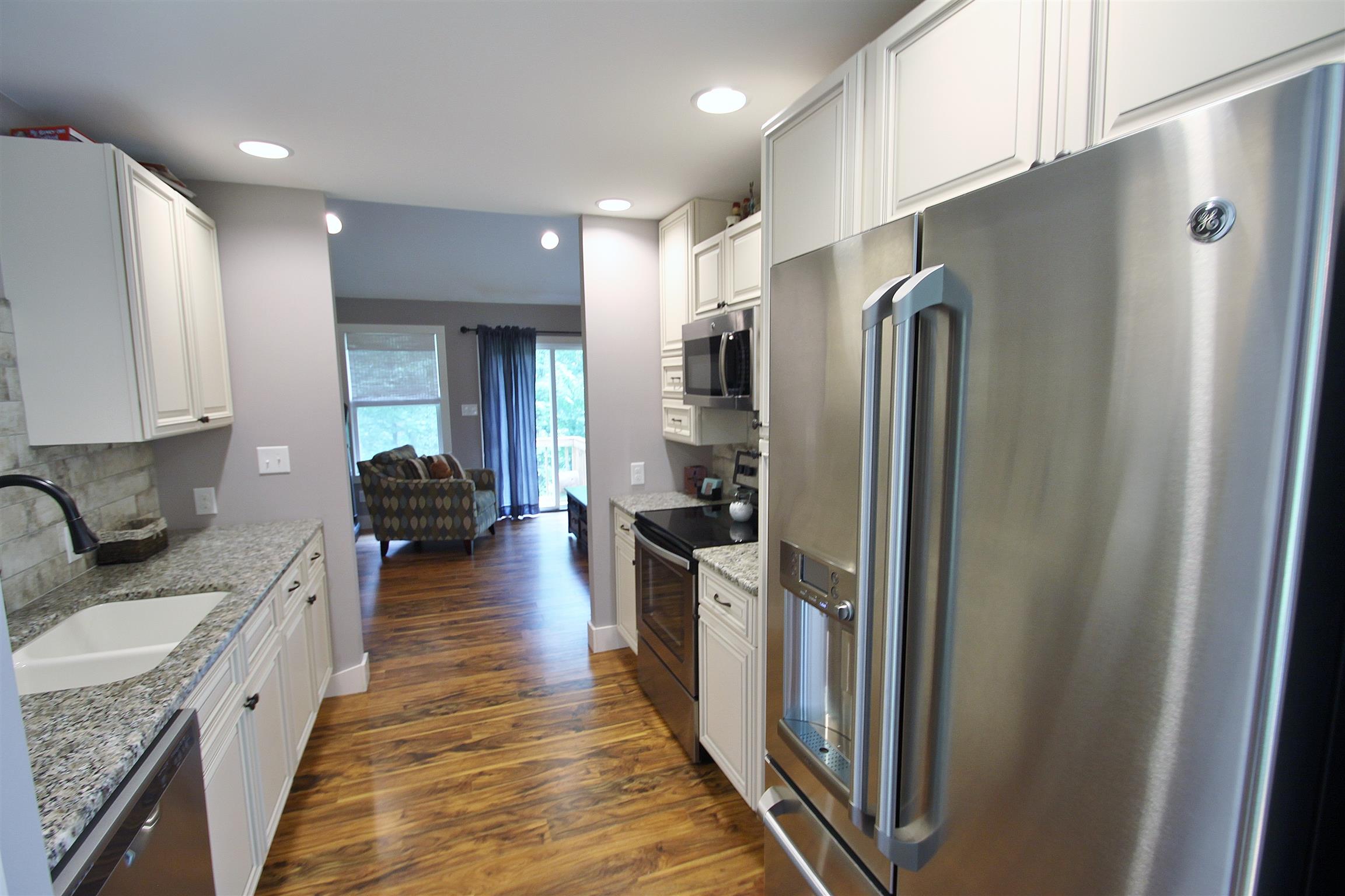 54 Snow Tree Bend Manchester, TN 37355 - Photo 5 of 16 a kitchen with stainless steel appliances granite countertop a refrigerator a stove and a sink