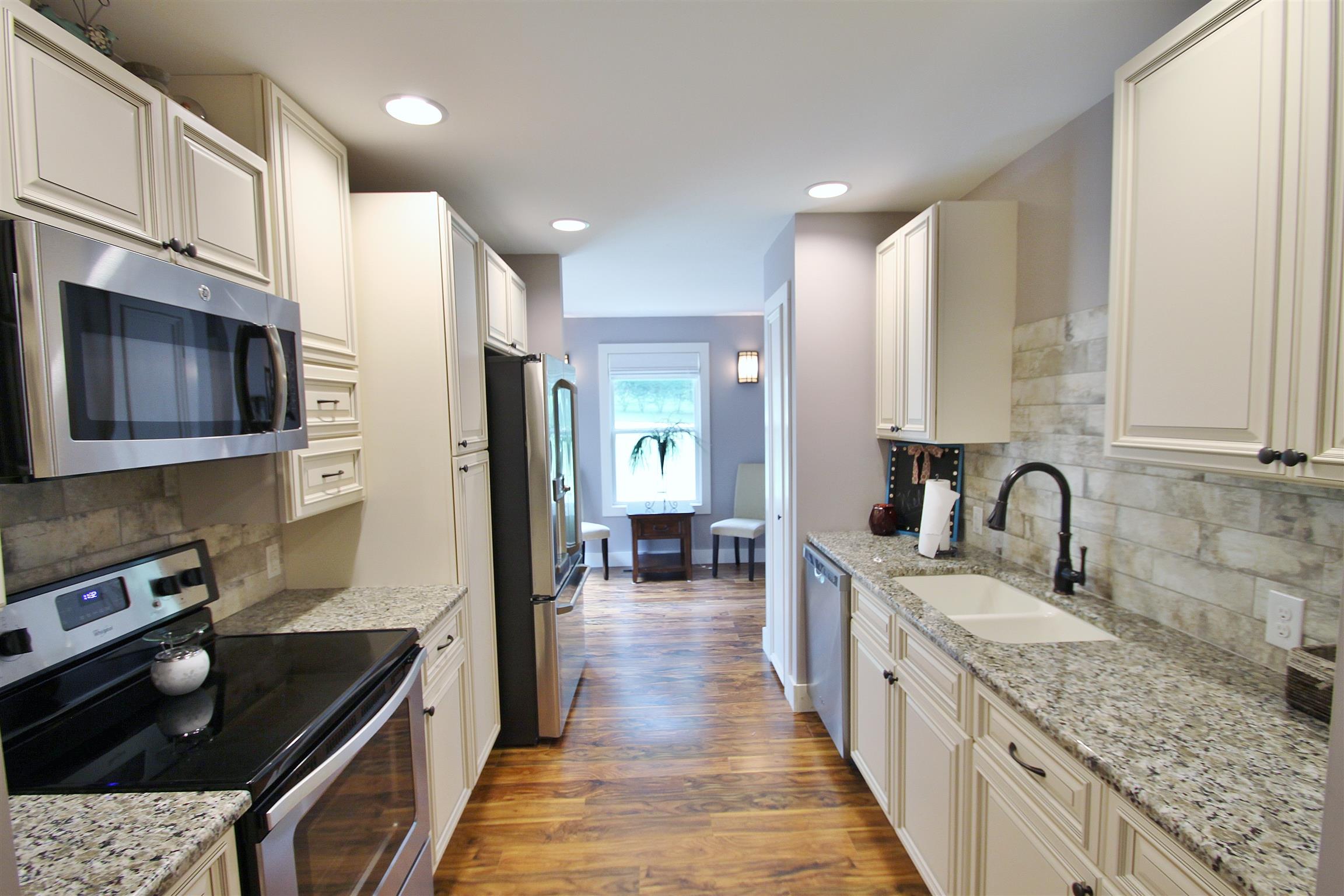 54 Snow Tree Bend Manchester, TN 37355 - Photo 6 of 16 a kitchen with stainless steel appliances granite countertop a sink stove and refrigerator