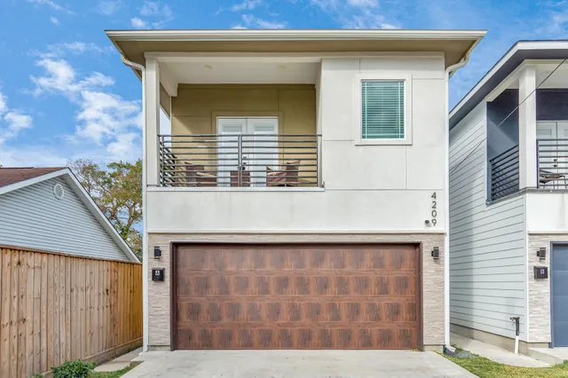 a front view of a house with large windows