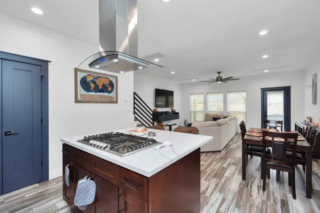 a large kitchen with a table and chairs