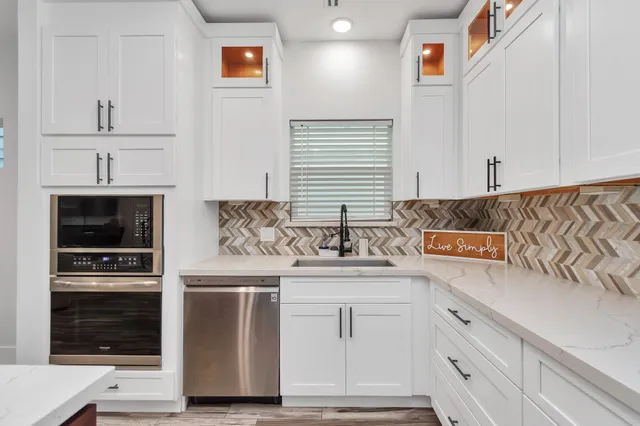 a kitchen with stainless steel appliances granite countertop a stove and a sink