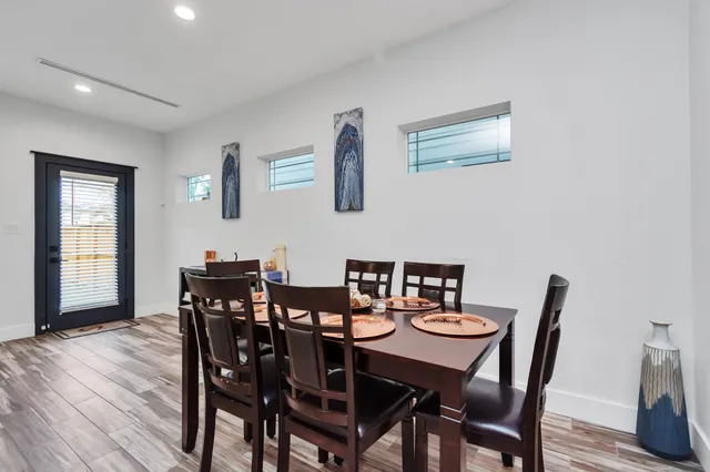 a view of a dining room with furniture and wooden floor