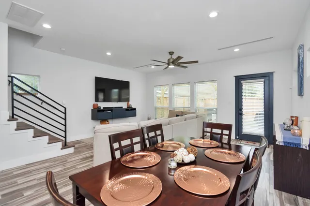 a dining room with furniture and a flat screen tv