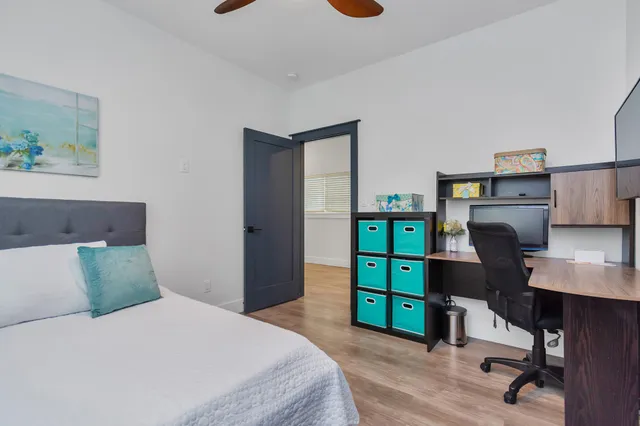 a bedroom with furniture and a wooden floor