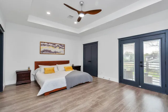 a bedroom with a bed and a large window