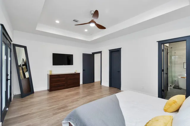 a bedroom with a bed and a flat screen tv