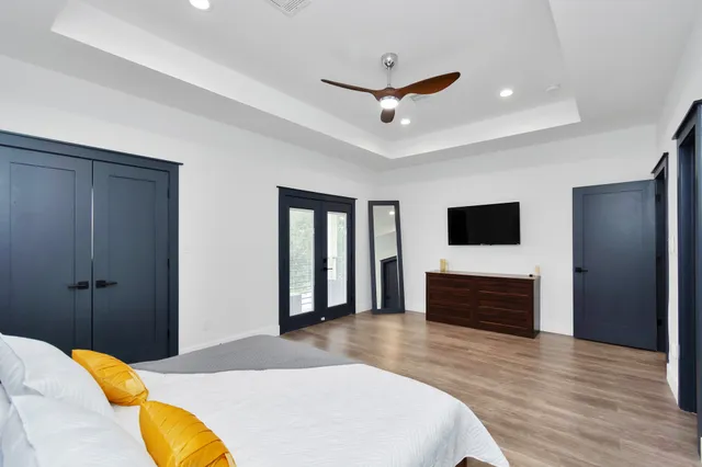 a bedroom with a bed and a flat screen tv