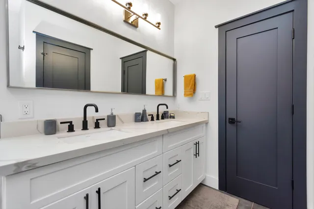 a bathroom with a sink vanity and mirror