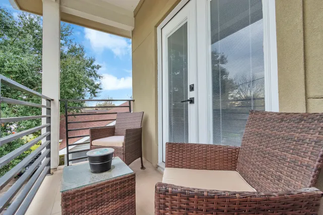 a view of a bedroom with wooden floor and stairs