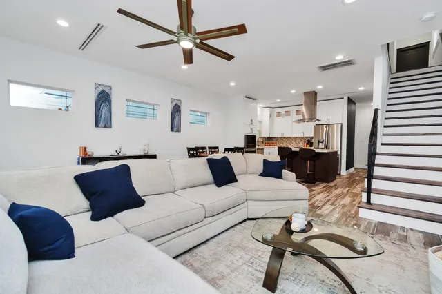 a living room with furniture or couch and a ceiling fan