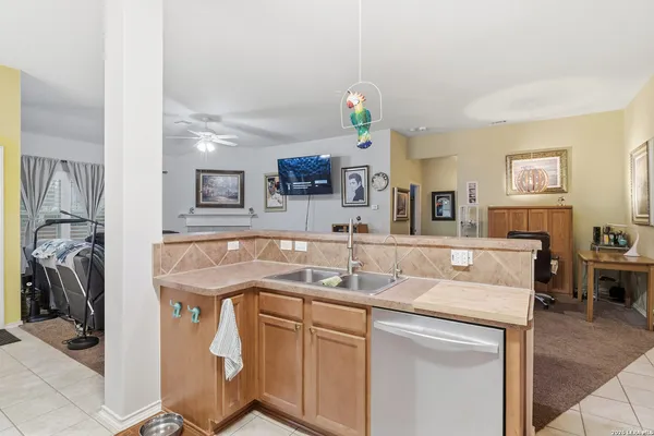 a view of a kitchen with a sink and a refrigerator