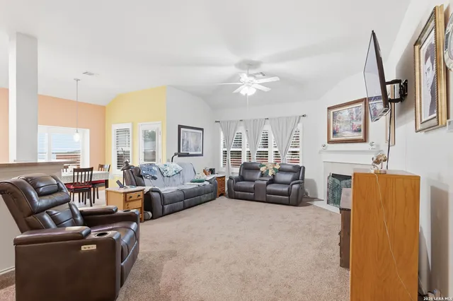 a living room with furniture fireplace and a large window