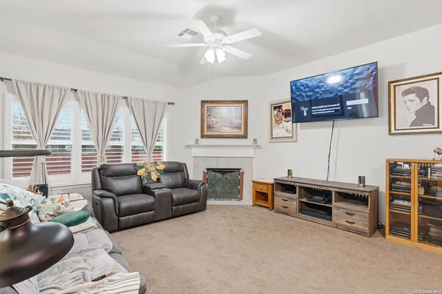a living room with furniture a large window and a flat screen tv