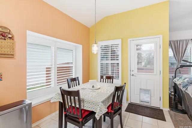a view of a dining room with furniture and windows