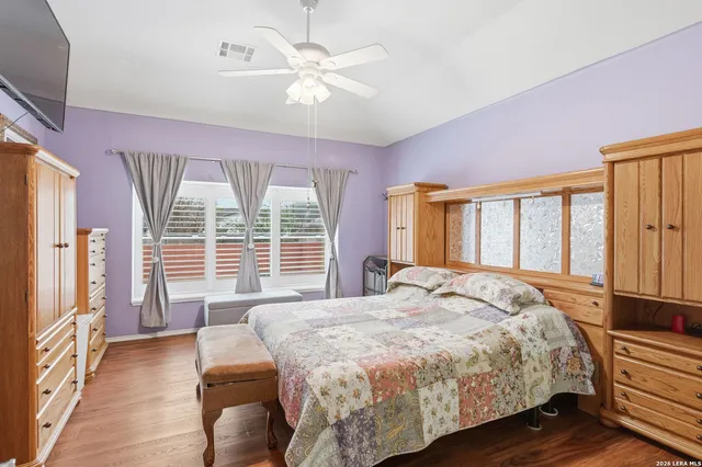 a bedroom with a large bed and a large window