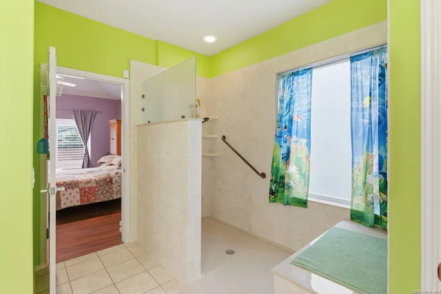 a bedroom with a bed and a view of bathroom