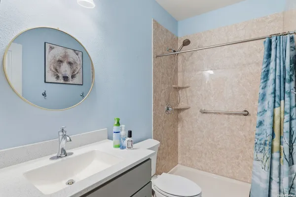 a bathroom with a sink toilet and shower