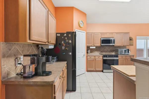 a kitchen with a stove a sink and a refrigerator