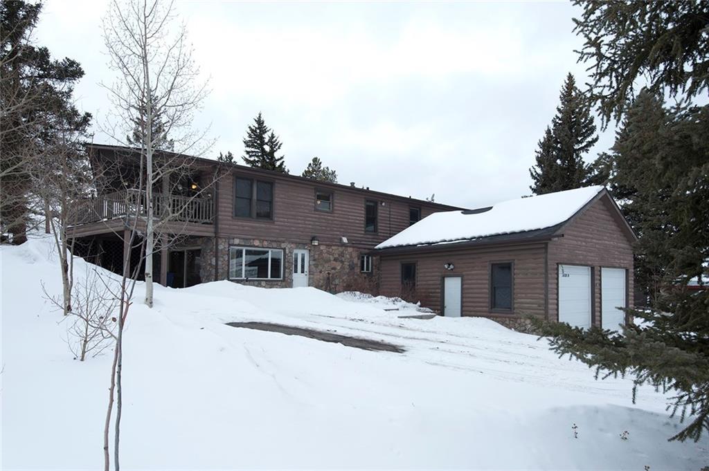 a large house with a large tree in front of it