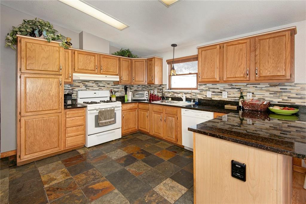 76 Lakeside Drive Dillon, CO 80435 - Photo 9 of 23 a kitchen with stainless steel appliances granite countertop a stove a sink dishwasher and a refrigerator