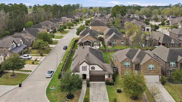 an aerial view of multiple houses with yard