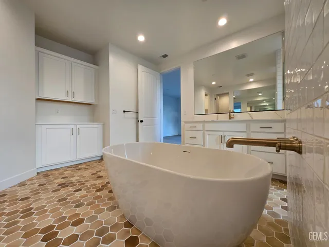 a large white kitchen with a sink