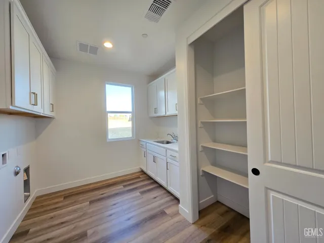 a room with wooden floors and white walls