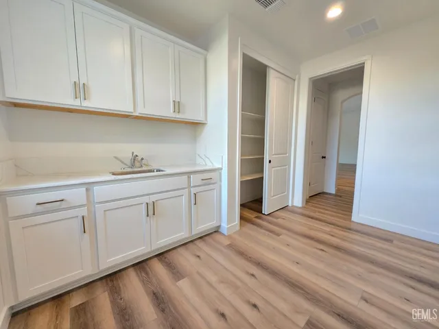 a view of a kitchen with wooden floor
